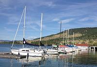 In the foreground, The Anne Marie pictured in her slip at Flathead Lake Montana awaiting an afternoon sailing session. In the foreground, The Anne Marie pictured in her slip at Flathead Lake Montana awaiting an afternoon sailing session.